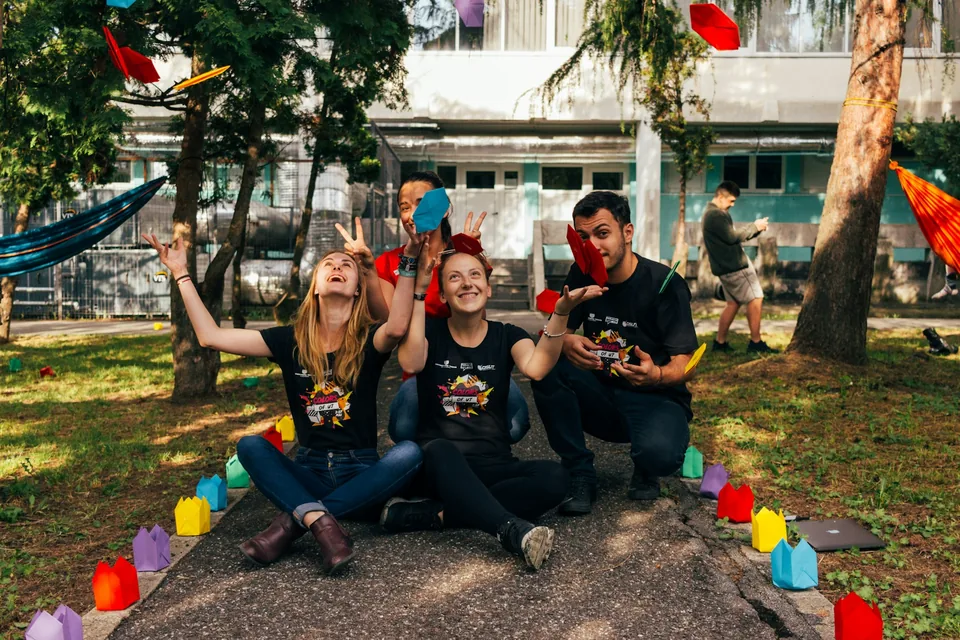 A group of people sitting together outdoors, taking part in a community activity